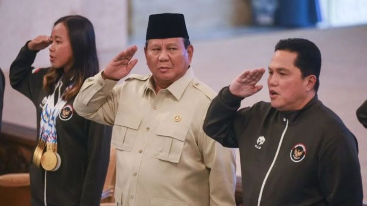 Presiden Prabowo Subianto (tengah) didampingi Menpora Erick Thohir (kedua kanan) bersama atlet triathlon Martina Ayu Pratiwi (kiri) menyanyikan lagu Indonesia Raya saat penyerahan bonus kepada atlet peraih medali pada SEA Games Thailand di Istana Negara. (Foto: Antara)